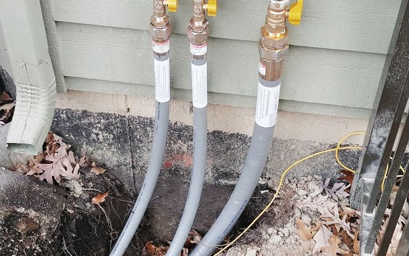 a-couple-of-hoses-that-are-connected-to-a-fire-hydrant