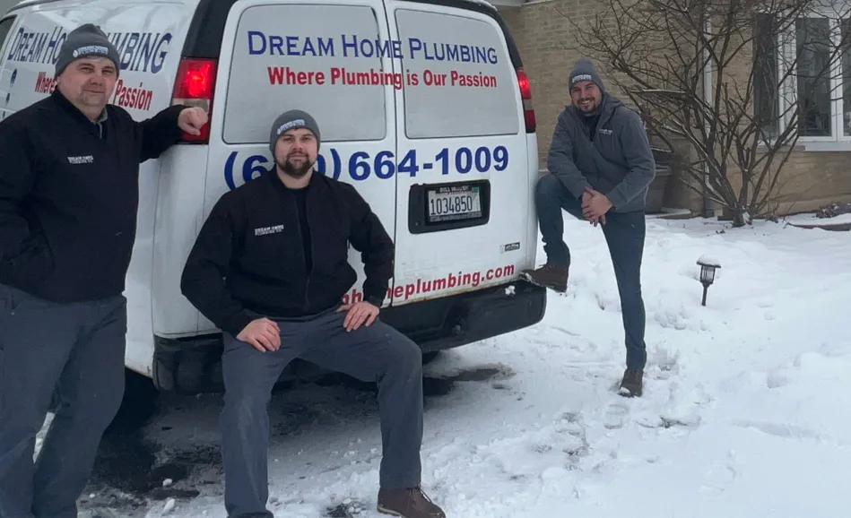 the-dream-home-plumbing-team-posing-behind-the-dream-home-van