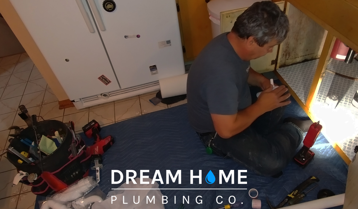 A local plumber repairing the pipes under the sink. Learn plumbing myths from experts.