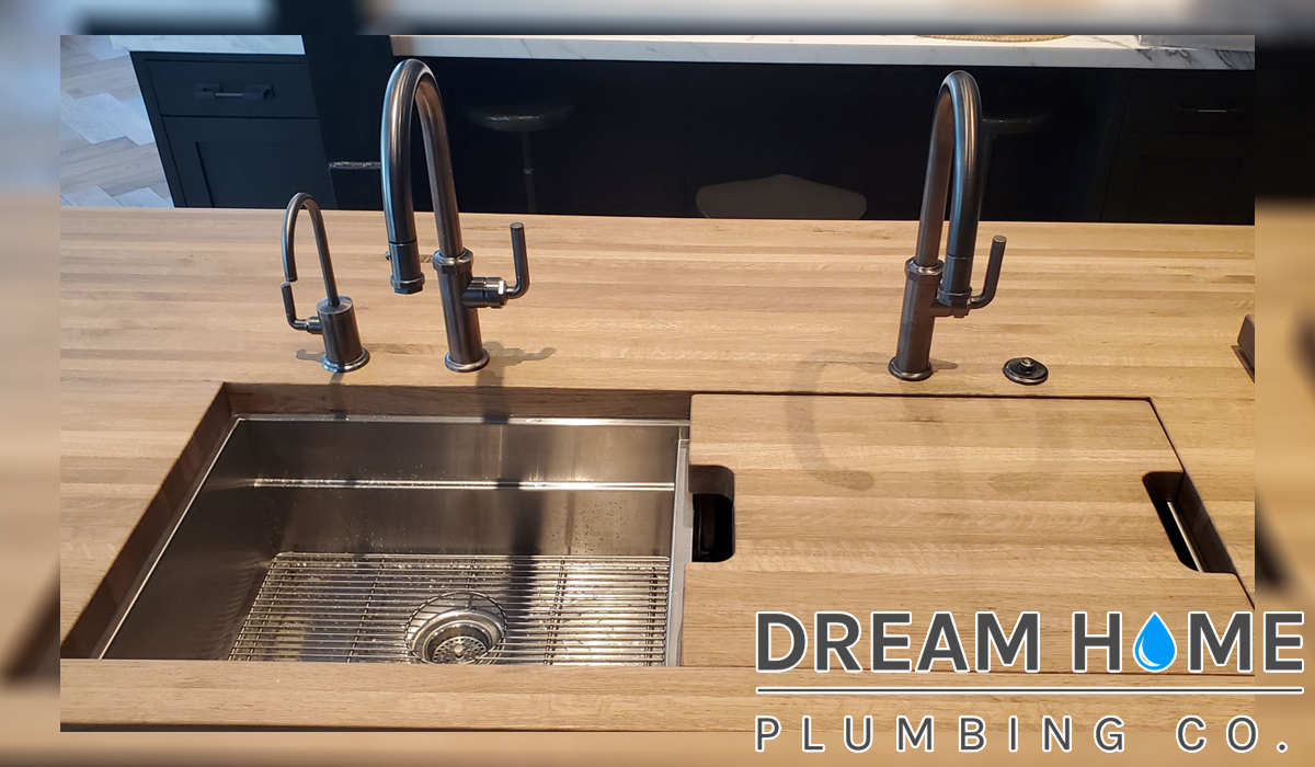 Modern wooden kitchen sink design. Call experts for top plumbing improvements.